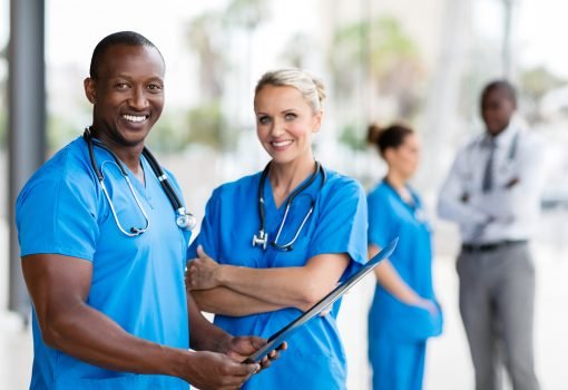 portrait of african medical doctor and female nurse in office